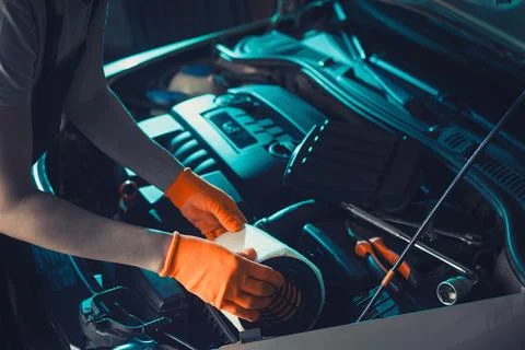 Auto mechanic is changing the air filter in the car Stock Photos