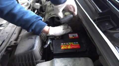 Auto mechanic changing a car battery Stock Footage 35212503