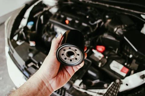 Auto mechanic changing oil filter, new engine oil filter replacement, Autom.. Stock Photos