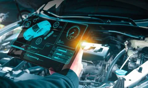 Auto mechanic checking engine system with OBD2 wireless scanning tool Stock Photos
