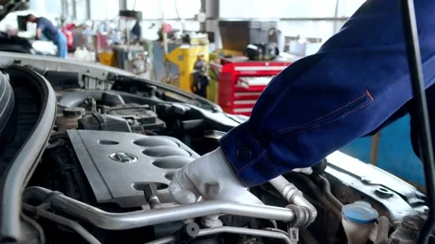 Auto mechanic checks the car engine oil Stock Footage 158507641