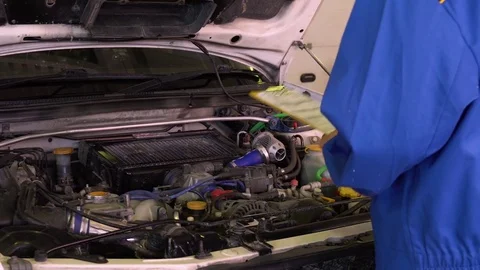 Auto mechanic checks car testing results in garage with tablet in his hands Stock Footage 75686434