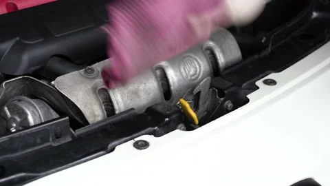 An auto mechanic is cleaning the engine compartment. car service. close-up. 動画素材 204879039