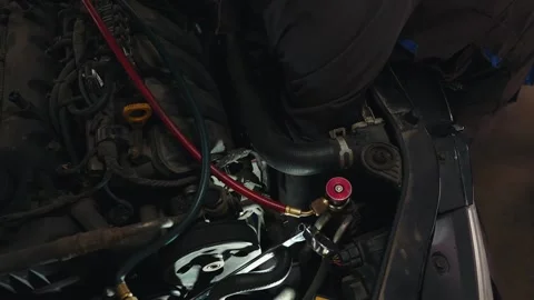 Auto mechanic close-up in the engine compartment looking for a fault Stock Footage 284543683