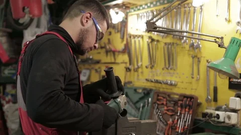 The auto-mechanic cut off the pipe with angle grinder.  Stock Footage 81242121