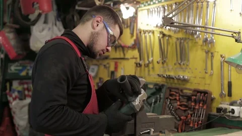 The auto-mechanic cut off the pipe with angle grinder.  Stock Footage 81242303