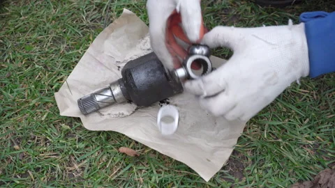 Auto mechanic demonstrates worn and broken CV joint of car Stock Footage 333303462