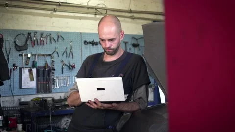 Auto mechanic diagnoses a car using a computer. car workshop Stock Footage 205231594