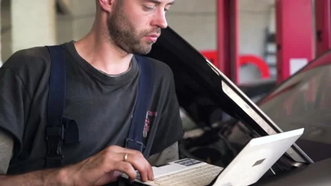 Auto mechanic diagnoses a car using a computer. car workshop. close-up Stock Footage 205509561