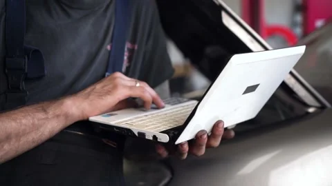 Auto mechanic diagnoses a car using a computer. car workshop. close-up Stock Footage 206077555