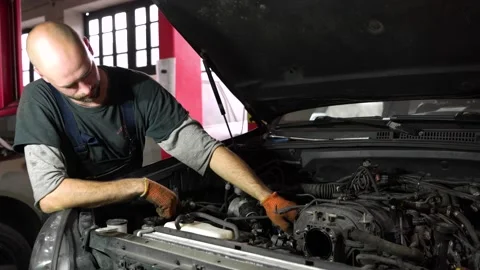 Auto mechanic is diagnosing an SUV engine. auto repair station. Stock Footage 204877142