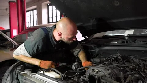 Auto mechanic is diagnosing an SUV engine. auto repair shop Stock Footage 205510417