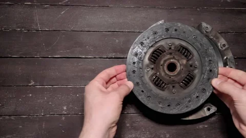 Auto mechanic disassembles and repairs car clutch disc Video stock 239718560