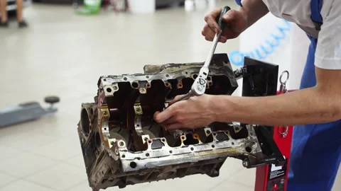 Auto mechanic disassembles engine block, extracts crankshaft at service station Stock Footage 261990515