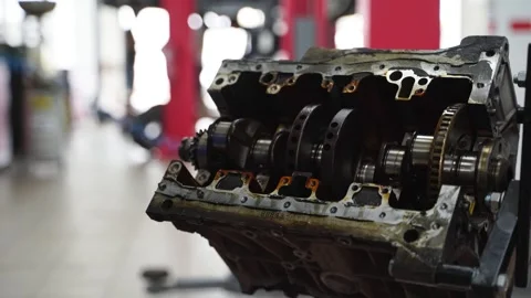 Auto mechanic disassembles engine, removes crankshaft in workshop. Professional Stock Footage 271595346