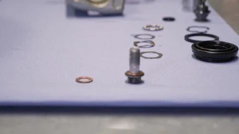 An auto mechanic disassembles or assembles a part from a car engine. Stock Footage 297839220