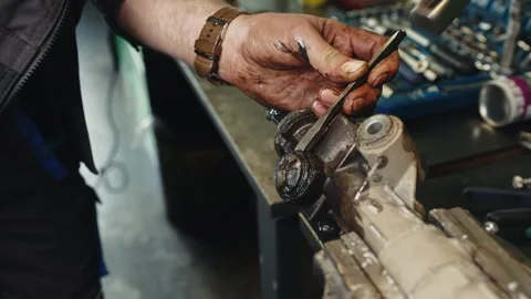 Auto mechanic dismantles steering rack process of repairing and replacing a Stock Footage 285641150