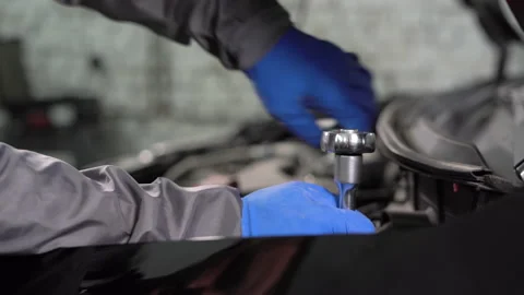 Auto mechanic hands over car engine repair to car workshop with wrench, car Stock Footage 157305683