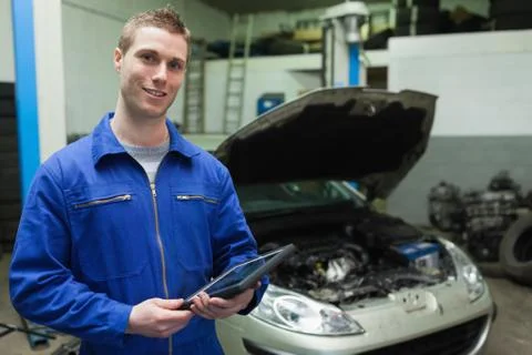 Auto mechanic holding tablet computer Stock Photos