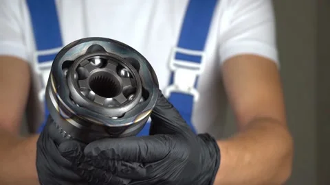 Auto mechanic holds in his hands hinge of equal angular velocities of car Stock Footage 221137745