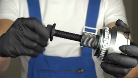 Auto mechanic holds in his hands hinge of equal angular velocities of car Stock Footage 221138083