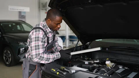 Auto mechanic inspecting car engine in workshop Stock Footage 300608759