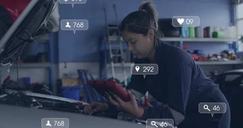 Auto mechanic inspecting engine bay and scrolling red tablet while social icons Video stock 312714362