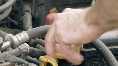 Auto mechanic pours additional motor engine oil Stock Footage 69999114