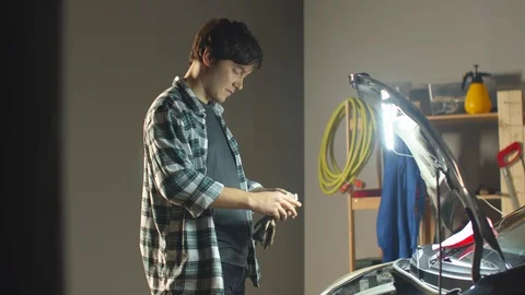 Auto mechanic puts on work gloves. Dirty work. Stock Footage 128181362