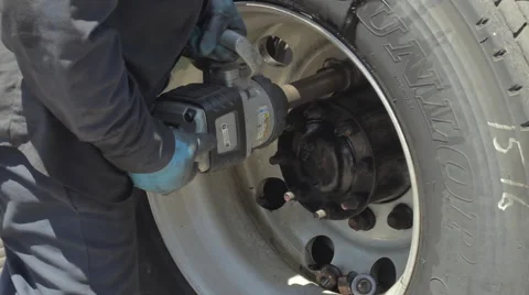 Auto mechanic removing nuts from concave freight liner truck tire Stock-Footage 60033191