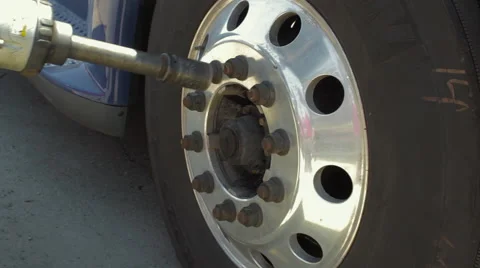 Auto mechanic removing nuts from convex freight liner truck tire 스톡 동영상 60035741