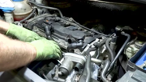 Auto Mechanic is repairing a car engine with defects Stock Footage 169828066