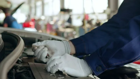 Auto mechanic repairing engine in auto repair shop Stock Footage 158506869