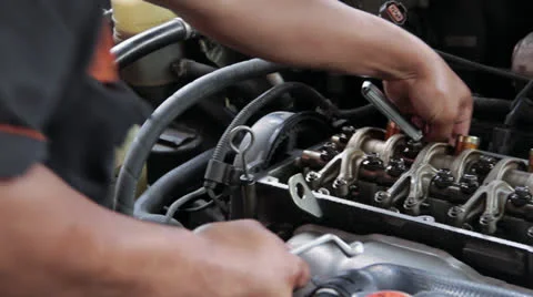 Auto Mechanic Repairing Engine Valves - Left to Right Dolly Shot Video stock 23802858