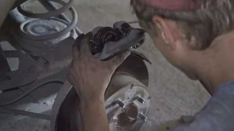 Auto mechanic repairs car chassis at station closeup Stock Footage 126108536