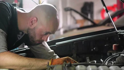 Auto mechanic repairs a car. engine repair. repair station. Stock Footage 204877194