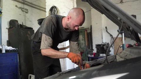 Auto mechanic repairs car engine. auto repair shop. Stock Footage 205509574