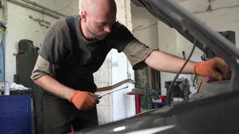 Auto mechanic repairs car engine. auto repair shop. diagnostics Stock Footage 206077480