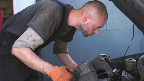 Auto mechanic repairs a car. engine repair. repair station. Stock Footage 206077677