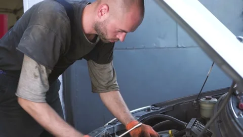 Auto mechanic repairs a car. engine repair. repair station. Stock Footage 207787954
