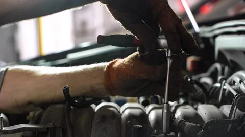 Auto mechanic repairs car engine. auto repair shop. diagnostics Stock Photos
