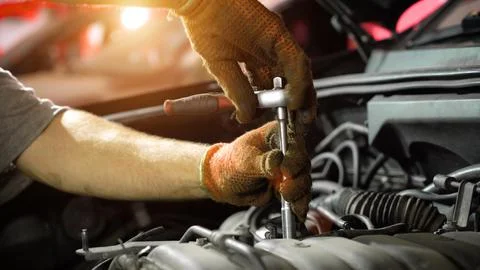 Auto mechanic repairs car engine. car service. auto repair shop. sunlight Stock Photos
