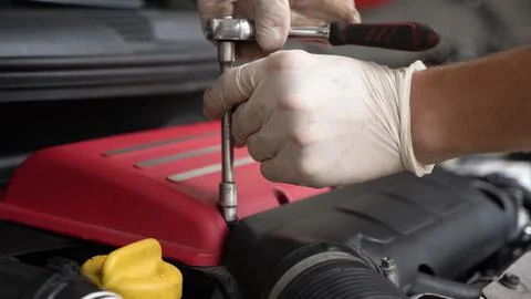 Auto mechanic repairs car engine. car service. close-up. Stock Photos