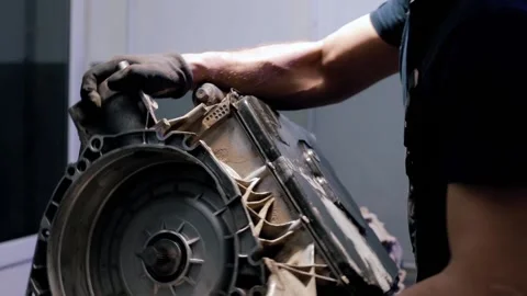 An auto mechanic repairs a gearbox in a modern car. professional car service. Stock Footage 239472010