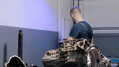Auto mechanic repairs gearbox in modern car. professional car service. Stock Footage 239474047