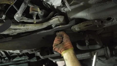 Auto mechanic repairs an old used car. auto repair shop. close-up. Stock Footage 215787589