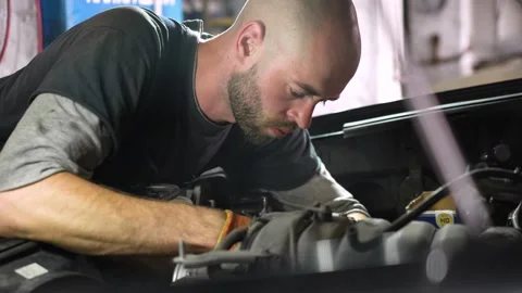 Auto mechanic repairs SUV engine. auto repair station. automobile Stock Footage 205232597