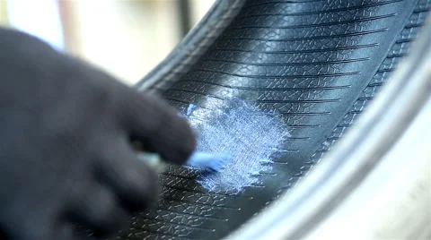 Auto mechanic repairs tire is Stock Footage 68026998