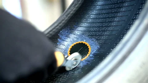 Auto mechanic repairs tire is Stock Footage 68027102