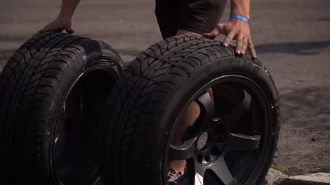 Auto mechanic rolls wheels.Full hd video Stock Footage 158636269
